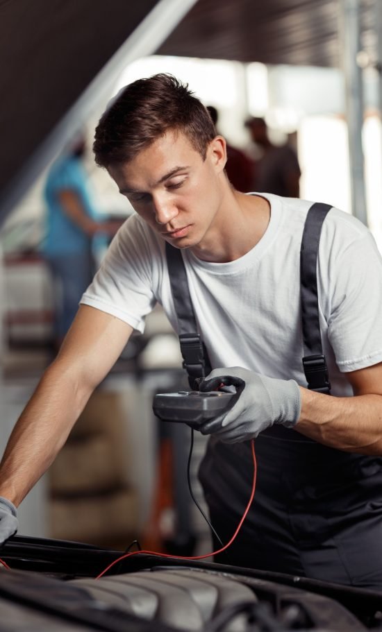 an-attractive-car-mechanic-is-checking-the-results-of-his-work-at-a-car-repair-service.jpg